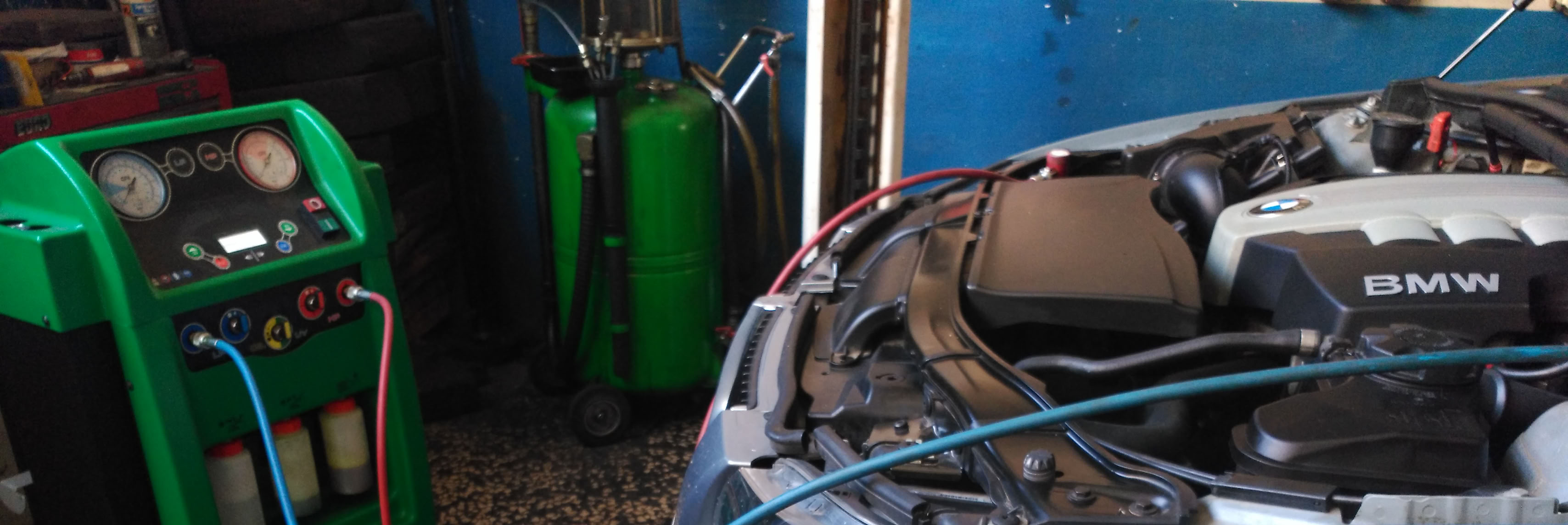 Foto de estación de carga de gas para aire-acondicionedo conectada a un vehículo.